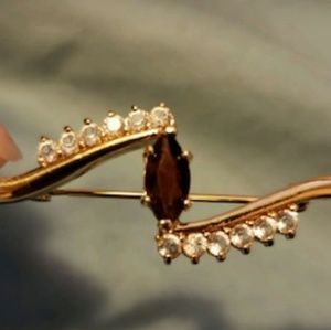 24k gold broohes.With diamonds and a ruby accent.